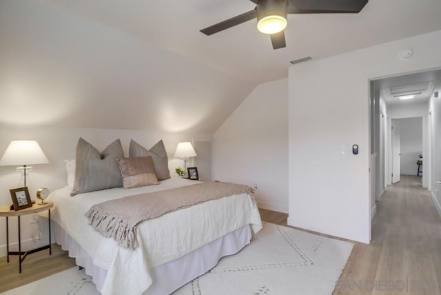 bedroom featuring vaulted ceiling, ceiling fan, and light hardwood / wood-style flooring