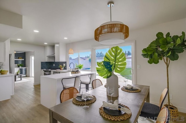 dining room with light hardwood / wood-style floors and sink