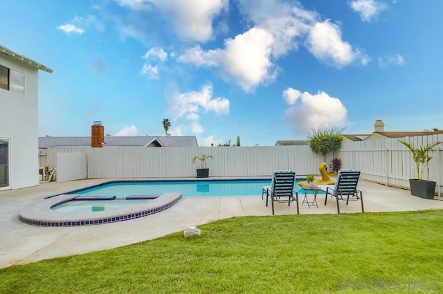 view of pool featuring an in ground hot tub, a patio area, and a lawn