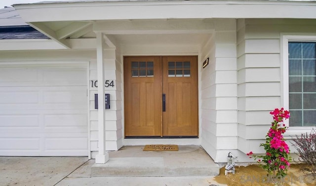 view of exterior entry with a garage