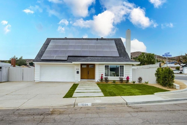 view of front facade featuring a garage and solar panels