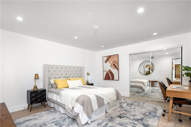 bedroom featuring a closet and light wood-type flooring