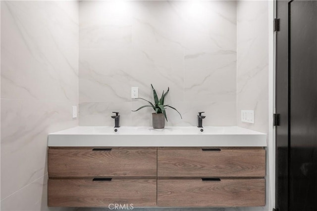 bathroom with tile walls and vanity