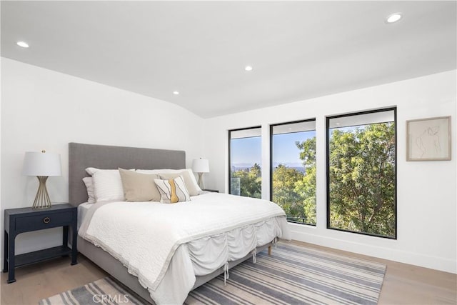 bedroom featuring lofted ceiling and hardwood / wood-style flooring