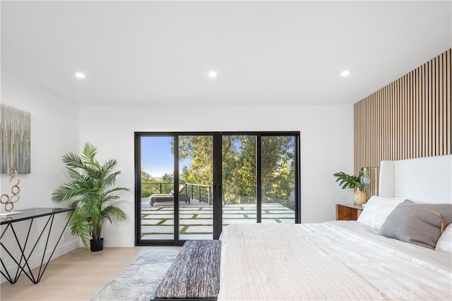 bedroom featuring access to exterior and light hardwood / wood-style flooring