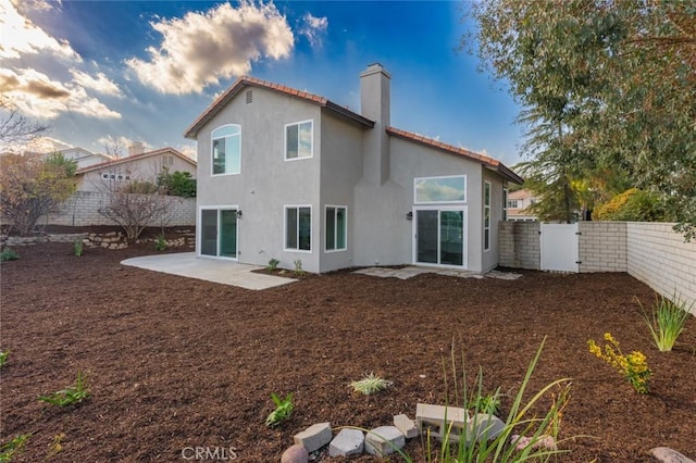 rear view of property featuring a patio area