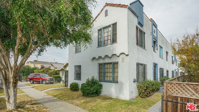 view of side of home featuring a yard