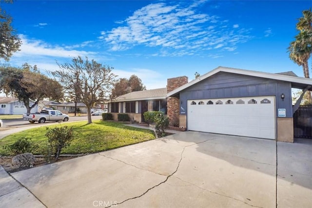 ranch-style home featuring a garage and a front lawn