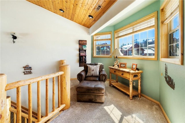 living area featuring vaulted ceiling, carpet flooring, and wooden ceiling