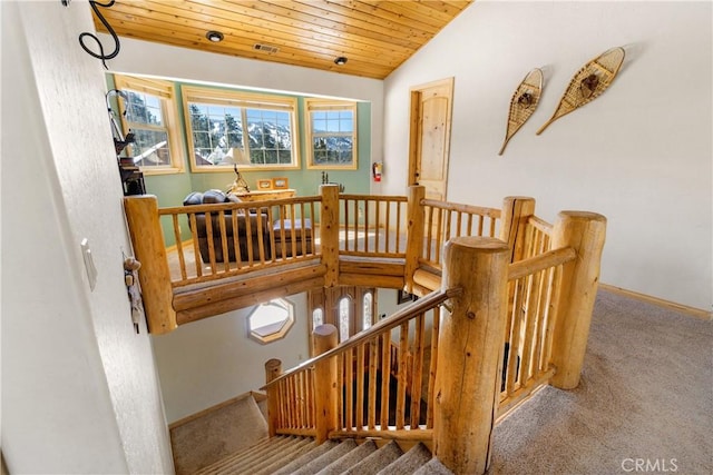 stairs featuring wooden ceiling, lofted ceiling, and carpet floors