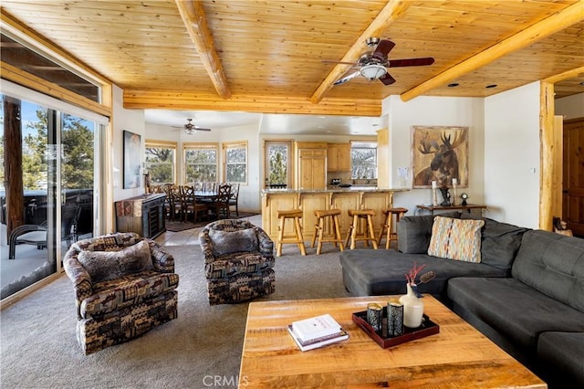 living room with ceiling fan, wooden ceiling, light carpet, and beamed ceiling