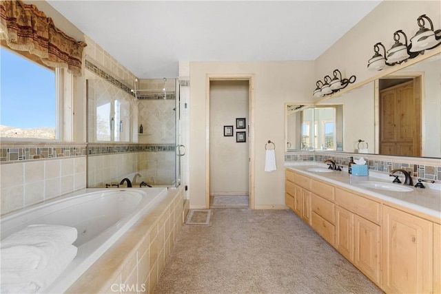 bathroom featuring vanity and independent shower and bath