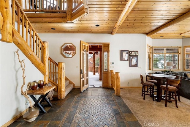 carpeted foyer with beam ceiling and wooden ceiling