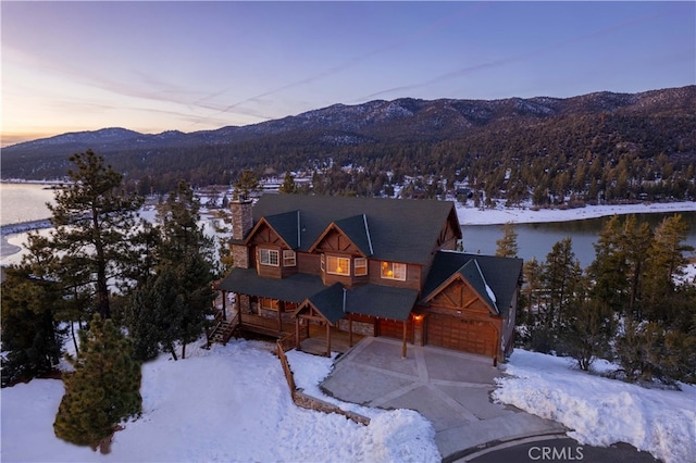 view of front facade featuring a water and mountain view