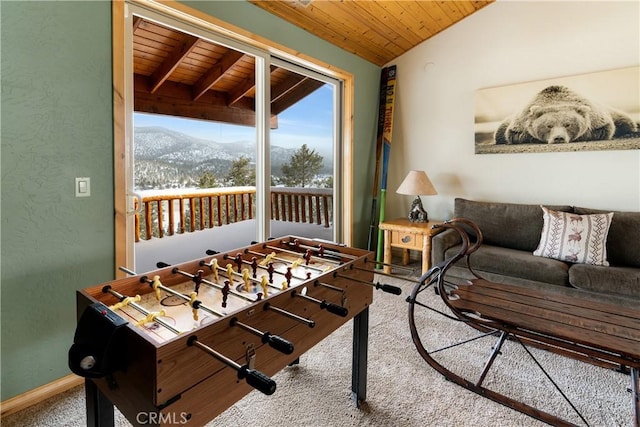 interior space with lofted ceiling, wood ceiling, carpet floors, and a mountain view