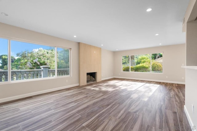 unfurnished living room featuring a fireplace and light hardwood / wood-style flooring