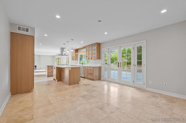 kitchen featuring dishwasher, a center island, french doors, a kitchen breakfast bar, and hanging light fixtures