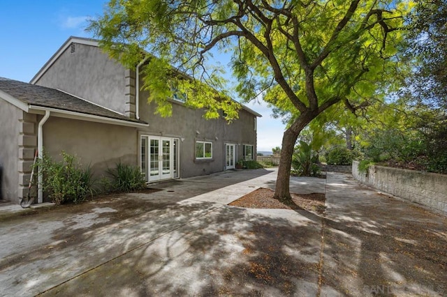 rear view of house with french doors and a patio