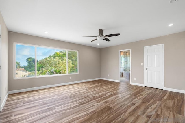 spare room with ceiling fan and light hardwood / wood-style flooring