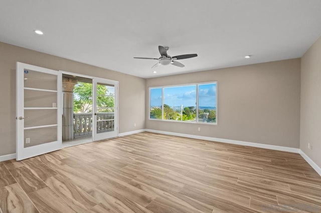 unfurnished room featuring ceiling fan, plenty of natural light, and french doors