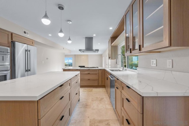 kitchen with exhaust hood, stainless steel appliances, a spacious island, pendant lighting, and sink