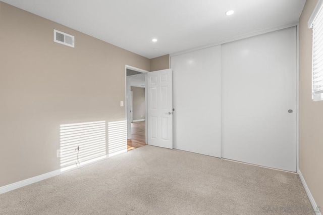 unfurnished bedroom featuring a closet and carpet