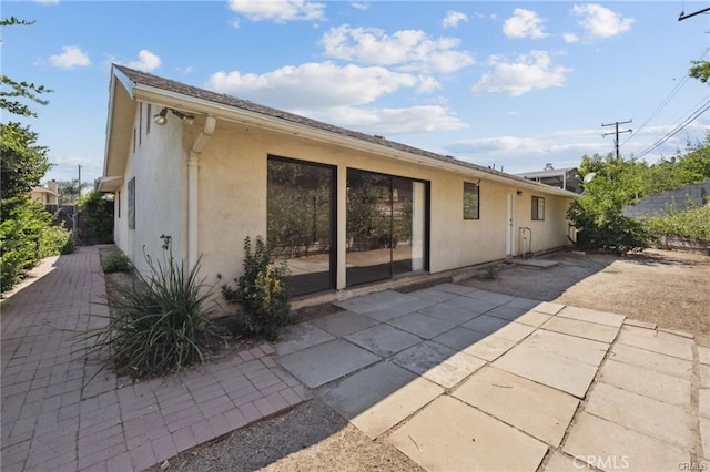 back of property with a patio