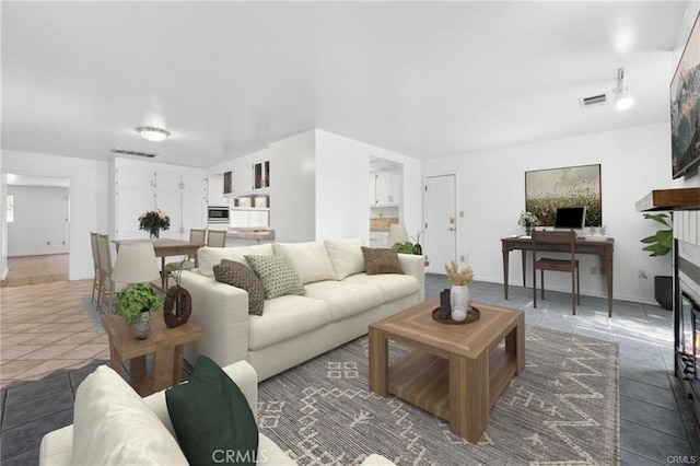 tiled living room featuring a fireplace