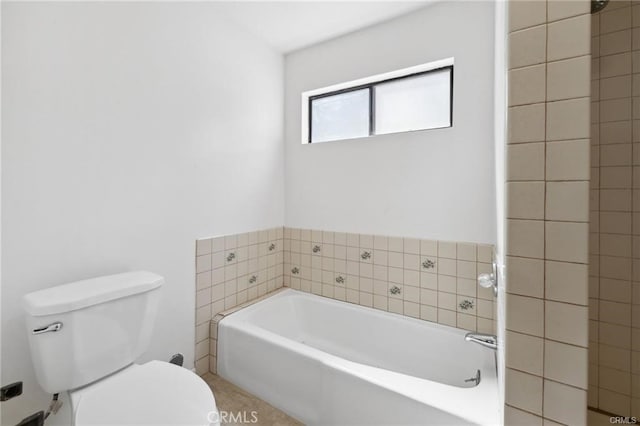 bathroom with toilet and a bathtub