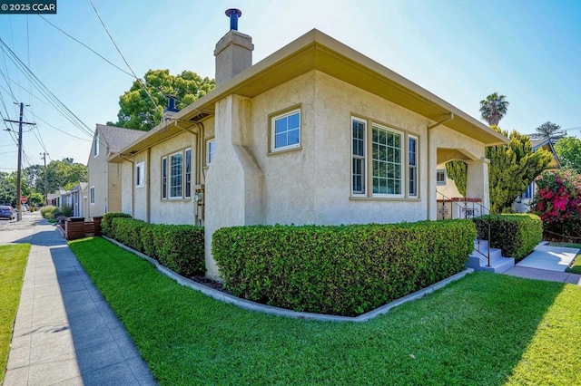 view of home's exterior featuring a lawn