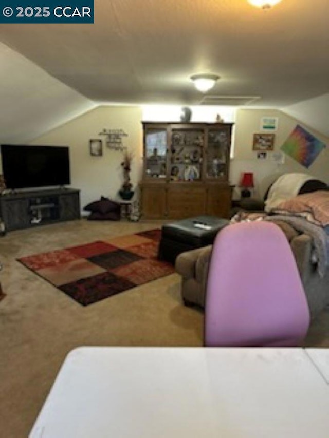 living room featuring lofted ceiling and carpet floors