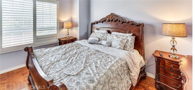 bedroom featuring dark wood-type flooring and multiple windows