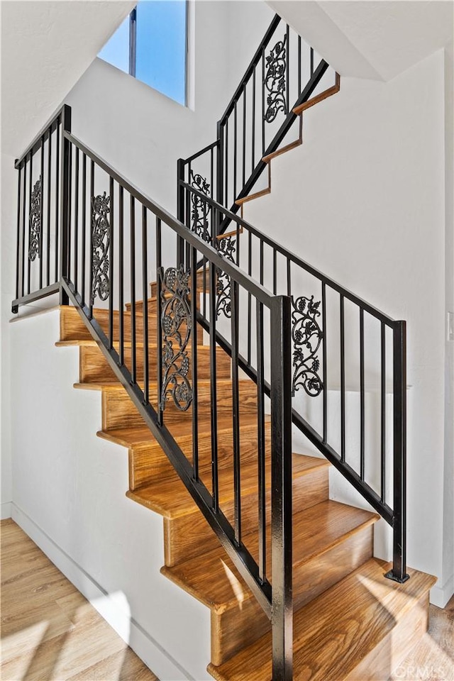 stairway with wood-type flooring