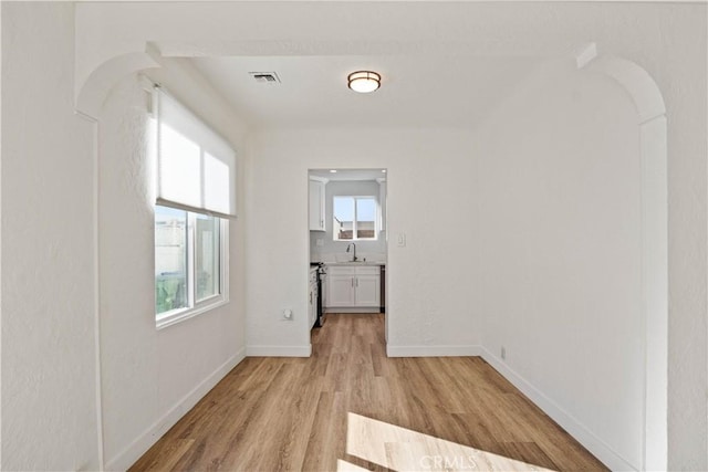 interior space featuring sink and light hardwood / wood-style flooring