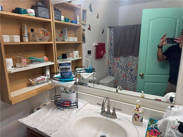 bathroom featuring toilet and vanity