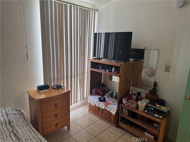 bedroom with light tile patterned floors