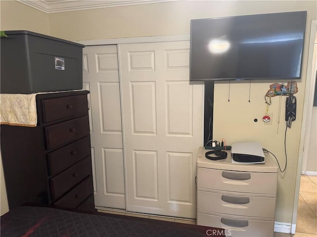 interior space with crown molding and tile patterned floors