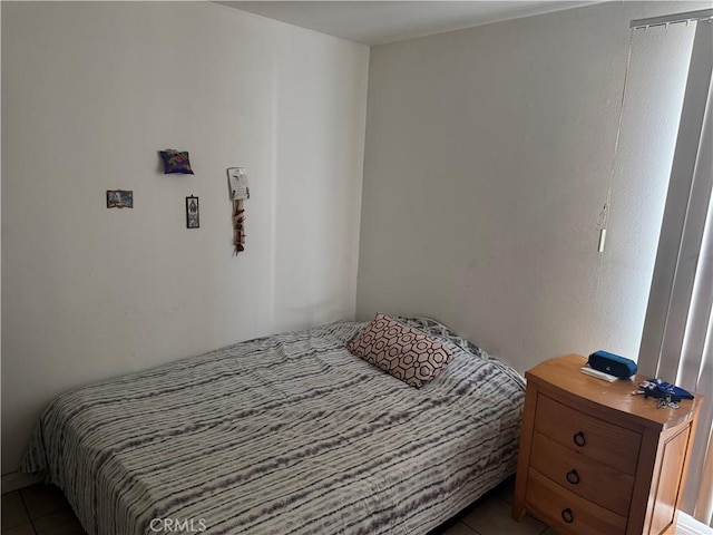 bedroom with dark tile patterned flooring