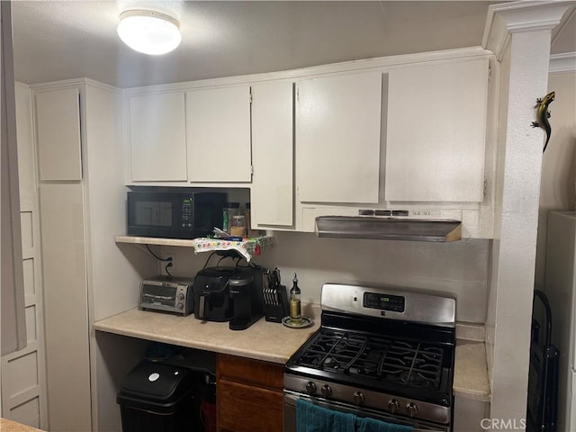 kitchen featuring stainless steel range with gas cooktop, white cabinets, and crown molding