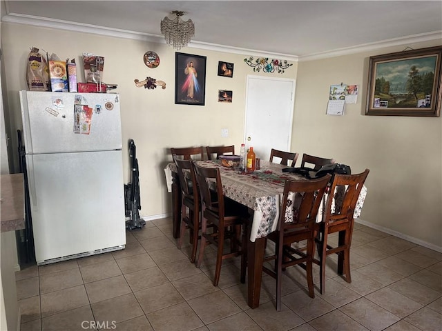 dining area featuring ornamental molding and tile patterned flooring