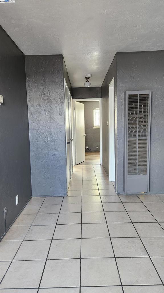 hallway featuring light tile patterned flooring