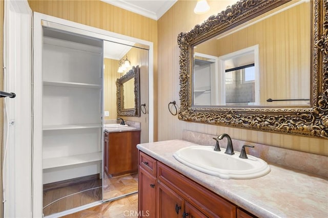 bathroom featuring vanity, parquet floors, and crown molding