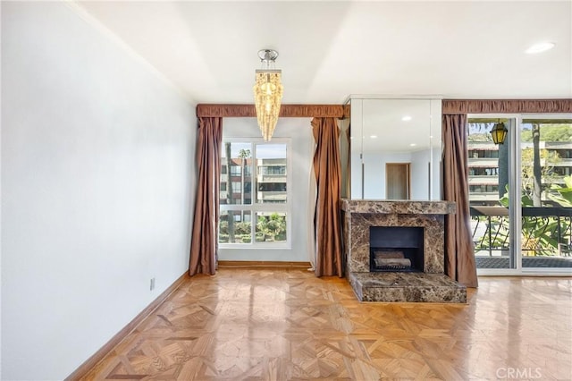 unfurnished living room featuring light parquet floors and a high end fireplace