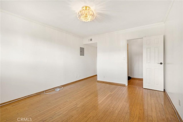 unfurnished room with crown molding and hardwood / wood-style flooring