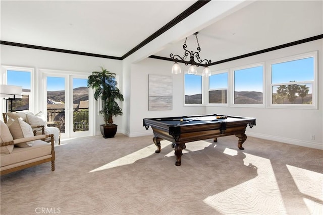 game room with a wealth of natural light, pool table, light carpet, a mountain view, and beam ceiling