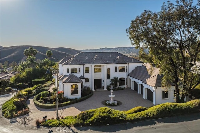 view of front of property with a garage and a mountain view