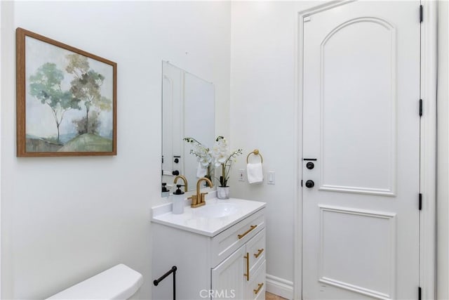 bathroom featuring toilet and vanity