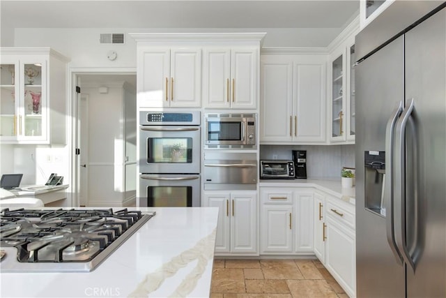 kitchen featuring white cabinetry and appliances with stainless steel finishes