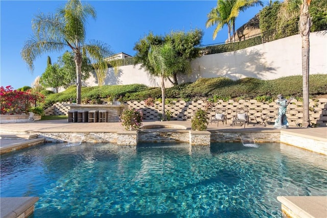 view of swimming pool featuring an outdoor bar and pool water feature