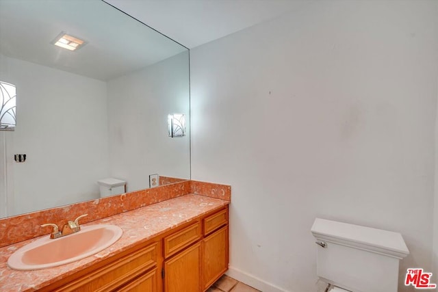 bathroom with tile patterned floors, toilet, and vanity